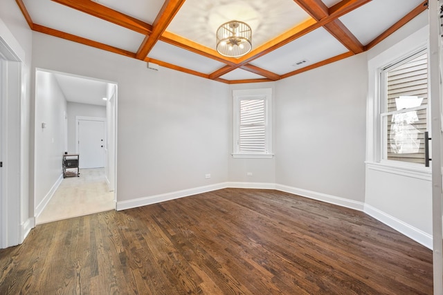 unfurnished room with beam ceiling, dark hardwood / wood-style floors, an inviting chandelier, and coffered ceiling