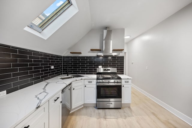 kitchen featuring light hardwood / wood-style flooring, tasteful backsplash, white cabinetry, stainless steel appliances, and extractor fan