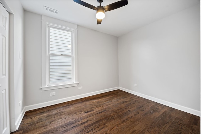 empty room with ceiling fan and dark hardwood / wood-style floors