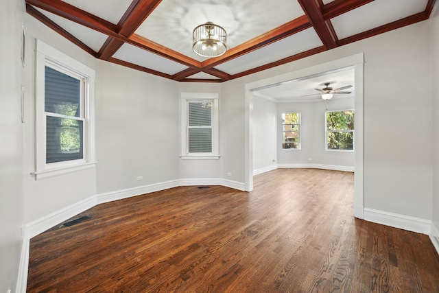 unfurnished room featuring beam ceiling, coffered ceiling, dark hardwood / wood-style flooring, crown molding, and ceiling fan with notable chandelier