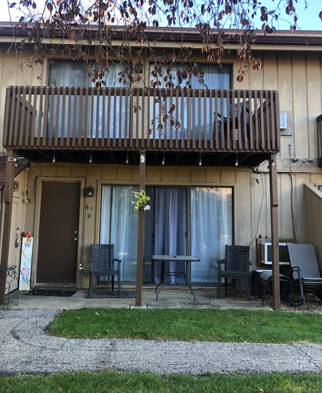 back of property with a patio area and a balcony