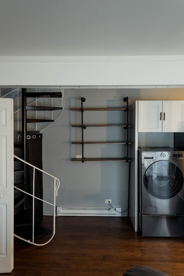 laundry area with baseboard heating, washer / clothes dryer, dark hardwood / wood-style flooring, and cabinets