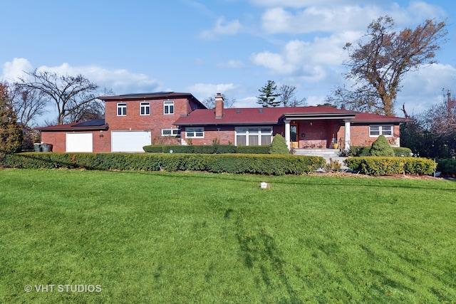 view of front of house featuring a front yard and a garage