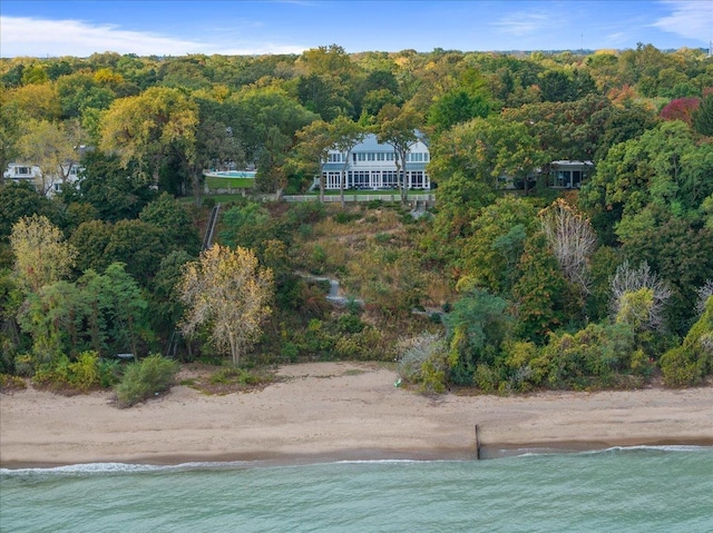 birds eye view of property with a water view and a view of the beach