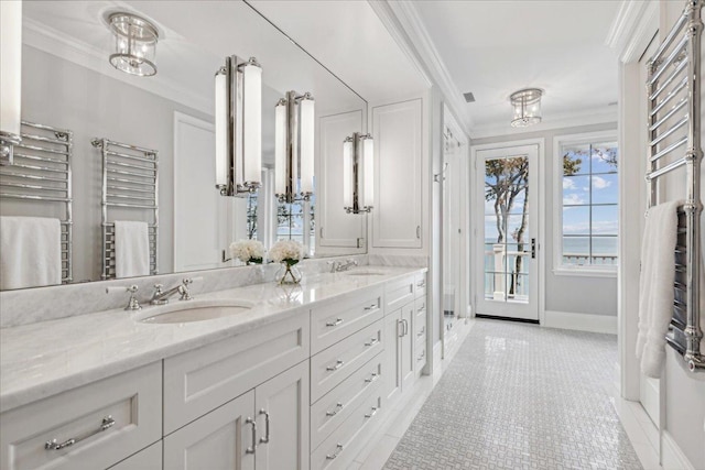 bathroom with ornamental molding and vanity