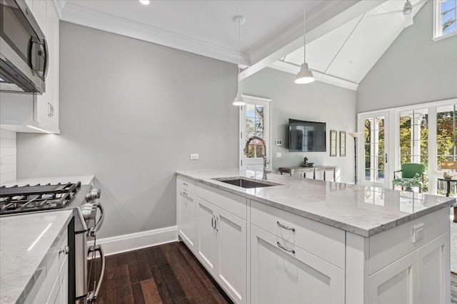 kitchen with pendant lighting, sink, appliances with stainless steel finishes, light stone counters, and white cabinets