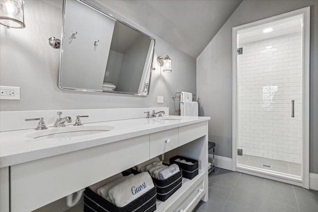 bathroom with lofted ceiling, vanity, a shower with shower door, and tile patterned flooring