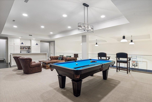 playroom with pool table, a tray ceiling, ornamental molding, and light colored carpet