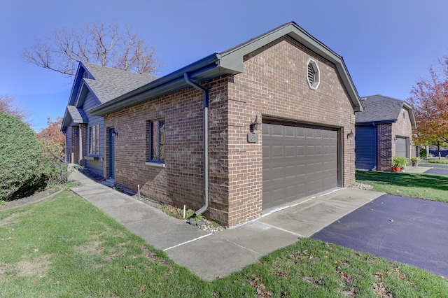 view of side of property with a yard and a garage