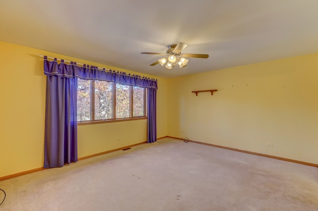 spare room with carpet flooring and ceiling fan