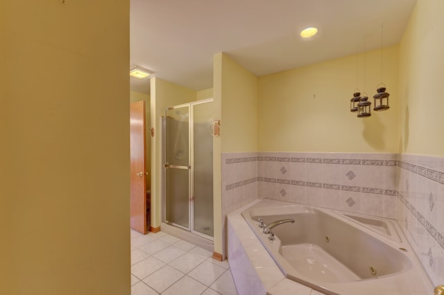 bathroom with tile patterned flooring and separate shower and tub