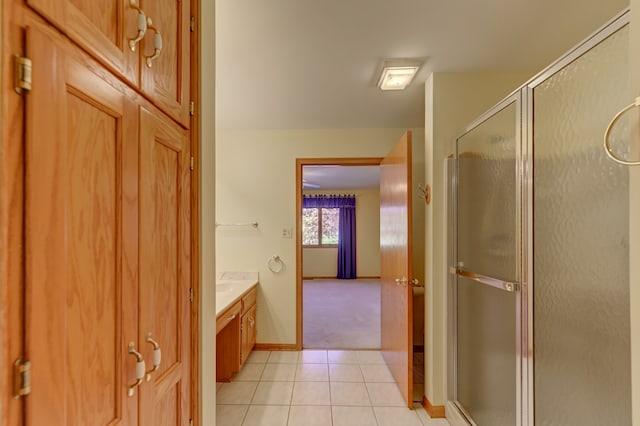 bathroom featuring vanity, tile patterned flooring, and walk in shower