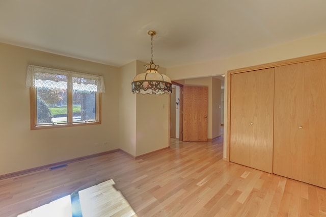 unfurnished dining area with light wood-type flooring