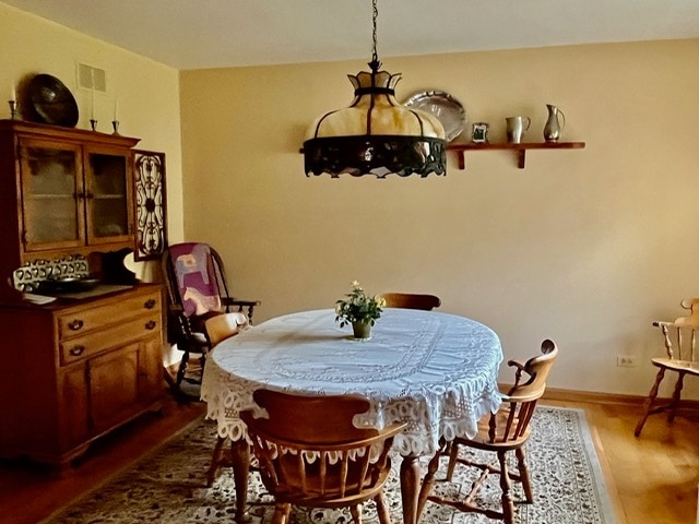 dining room with wood-type flooring