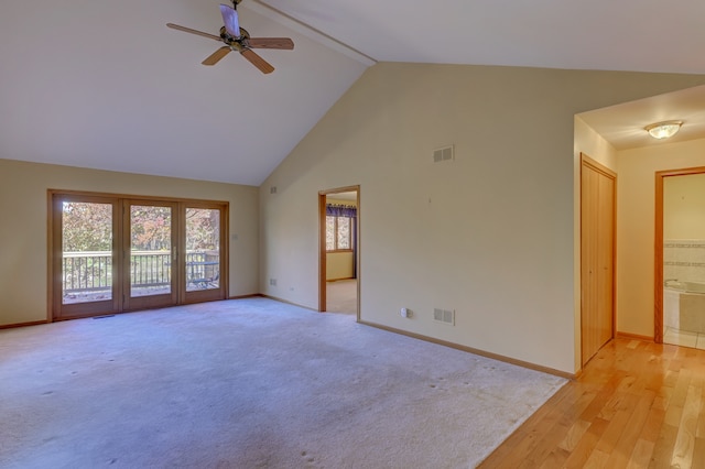 spare room with high vaulted ceiling, light wood-type flooring, and ceiling fan