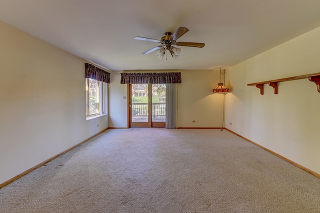 spare room featuring carpet flooring and ceiling fan