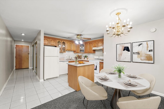 kitchen featuring hanging light fixtures, light tile patterned floors, a kitchen island, white appliances, and ceiling fan with notable chandelier