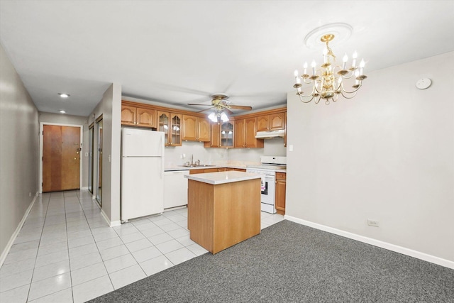 kitchen featuring pendant lighting, sink, a center island, light tile patterned floors, and white appliances