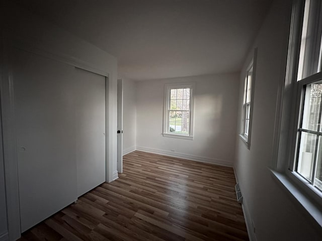 spare room with dark hardwood / wood-style flooring