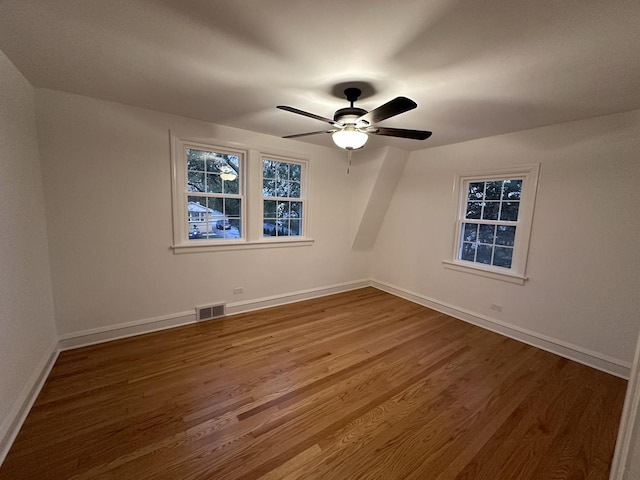 empty room with ceiling fan and hardwood / wood-style floors