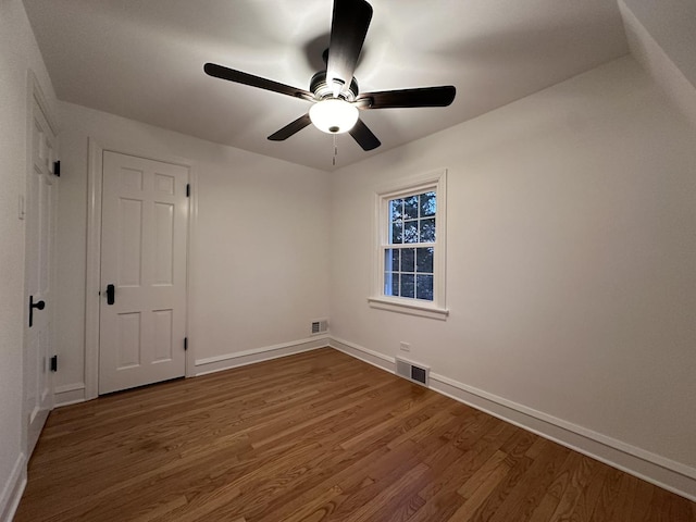 spare room featuring hardwood / wood-style floors and ceiling fan