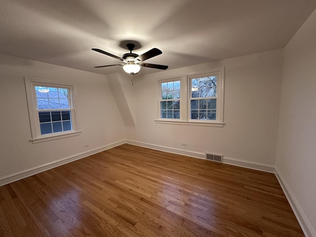 8646 S Nagle Ave, Burbank, IL 60459 - spare room with visible vents, wood finished floors, baseboards, and a healthy amount of sunlight