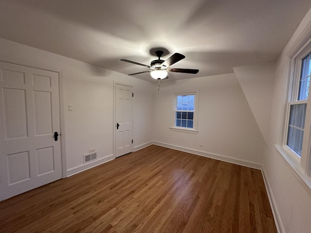 8646 S Nagle Ave, Burbank, IL 60459 - unfurnished bedroom featuring baseboards, ceiling fan, visible vents, and wood finished floors