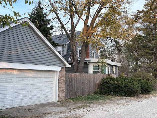 8646 S Nagle Ave, Burbank, IL 60459 - view of home's exterior with brick siding, a garage, and fence
