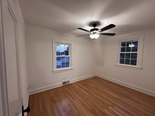 8646 S Nagle Ave, Burbank, IL 60459 - spare room with baseboards, visible vents, a ceiling fan, and wood finished floors