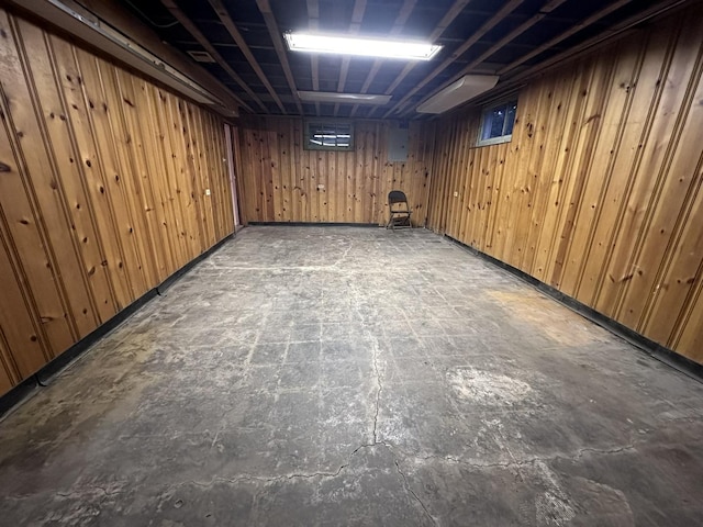 basement featuring wooden walls