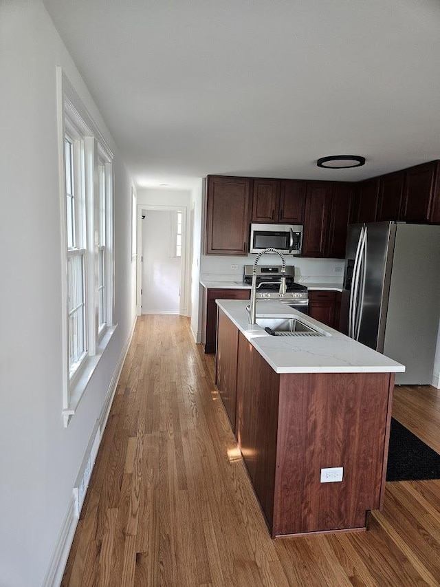 8646 S Nagle Ave, Burbank, IL 60459 - kitchen featuring a sink, light wood-type flooring, plenty of natural light, light countertops, and appliances with stainless steel finishes