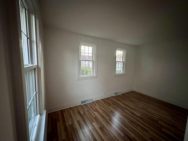 empty room with dark wood-type flooring