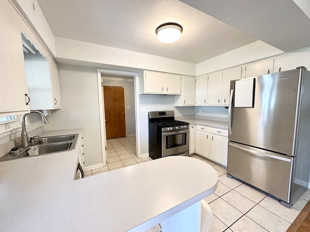 kitchen featuring white cabinetry, appliances with stainless steel finishes, sink, and light tile patterned floors