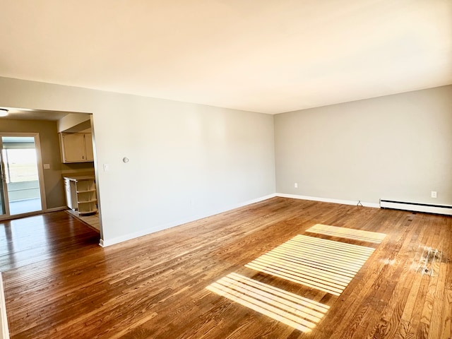 unfurnished room with hardwood / wood-style flooring and a baseboard radiator