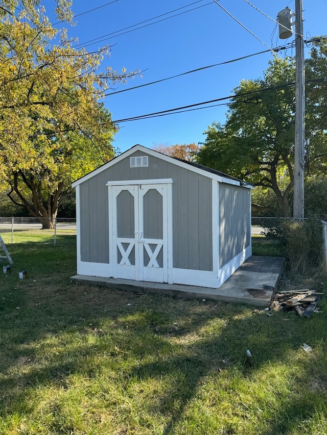 view of outbuilding featuring a lawn