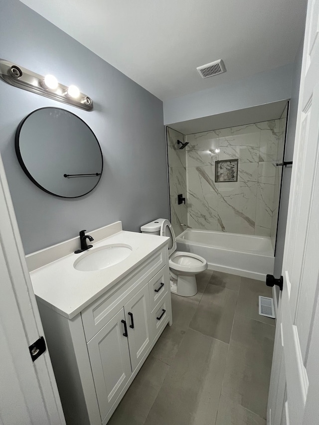 full bathroom featuring tile patterned flooring, vanity, toilet, and tiled shower / bath