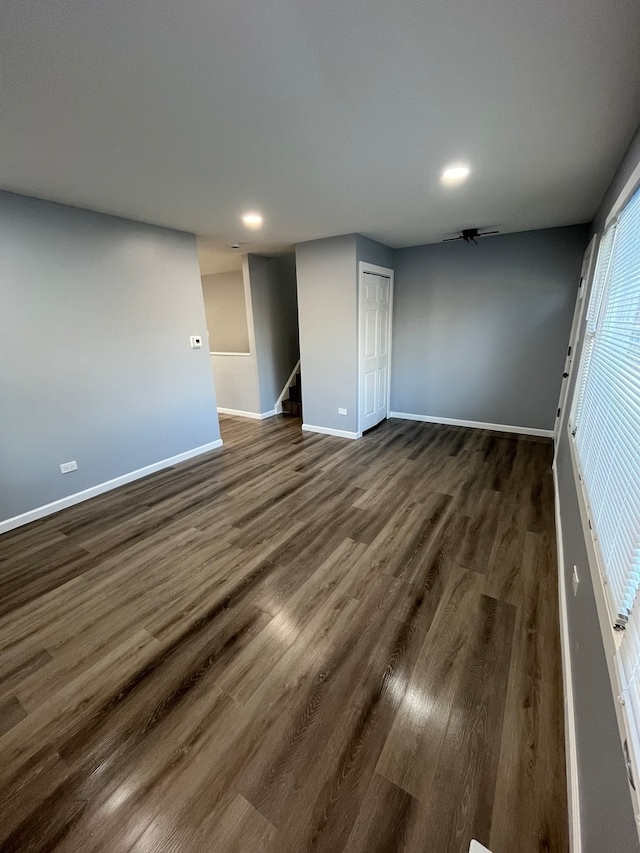 empty room featuring dark wood-type flooring and ceiling fan