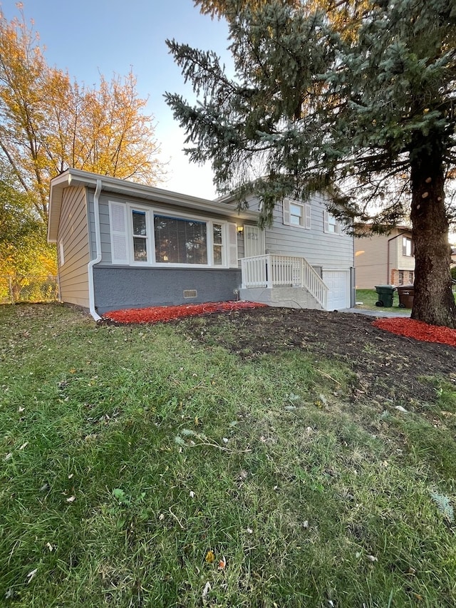 split level home featuring a front lawn