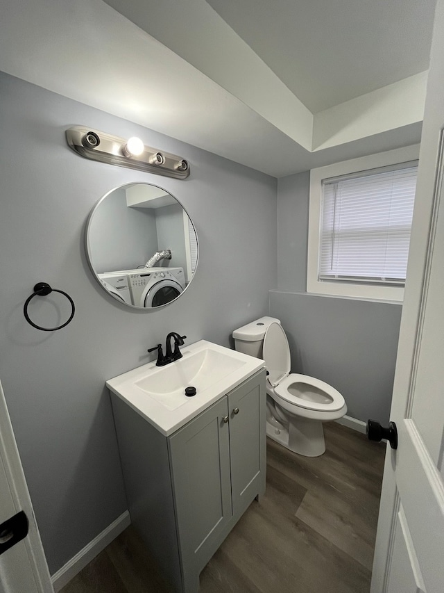 bathroom with hardwood / wood-style flooring, vanity, and toilet