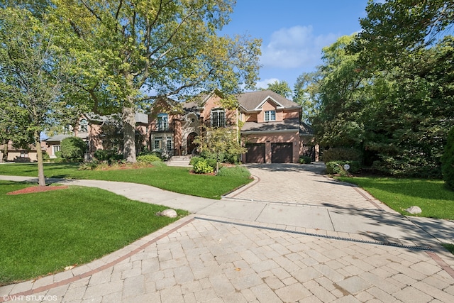 view of front of house featuring a front yard and a garage