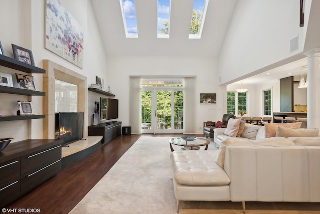 living room featuring dark wood-type flooring and high vaulted ceiling