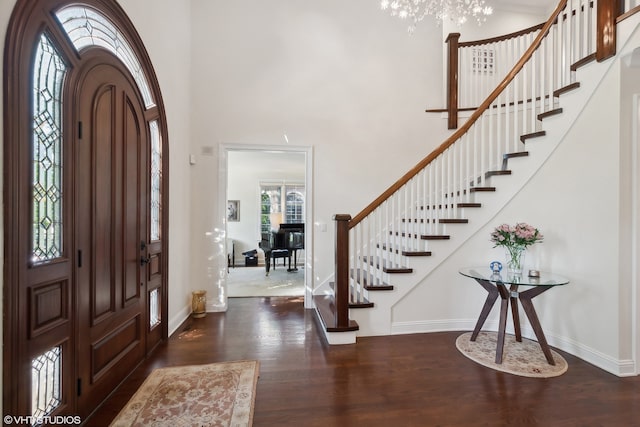 entrance foyer with a high ceiling and dark hardwood / wood-style flooring