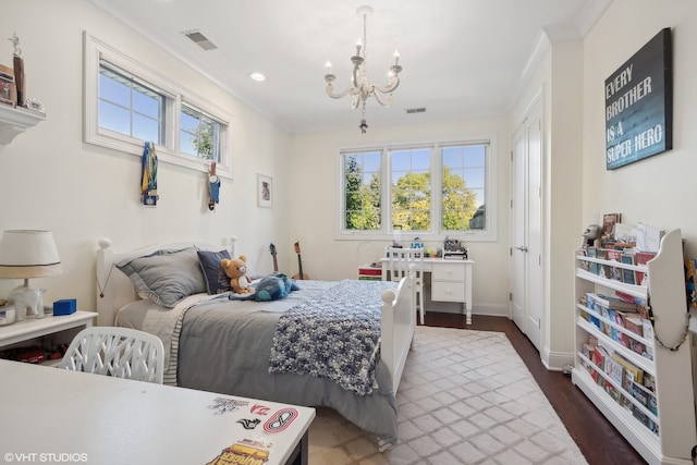 bedroom with dark wood-type flooring, crown molding, and an inviting chandelier