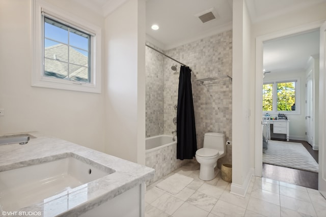 full bathroom featuring toilet, shower / bath combo, vanity, and plenty of natural light