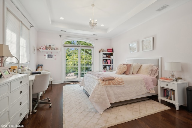 bedroom featuring an inviting chandelier, light hardwood / wood-style floors, access to exterior, and a tray ceiling