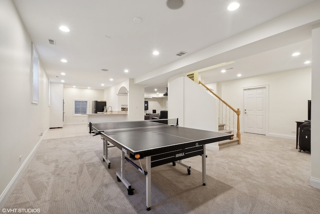 recreation room with light carpet