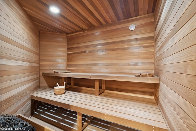 view of sauna / steam room with wood ceiling and wood walls