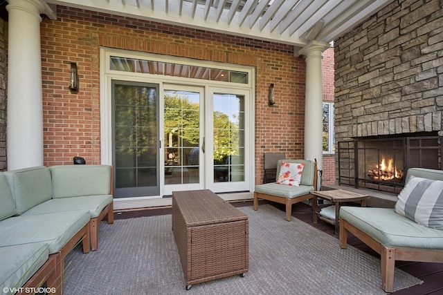 view of patio with an outdoor living space with a fireplace