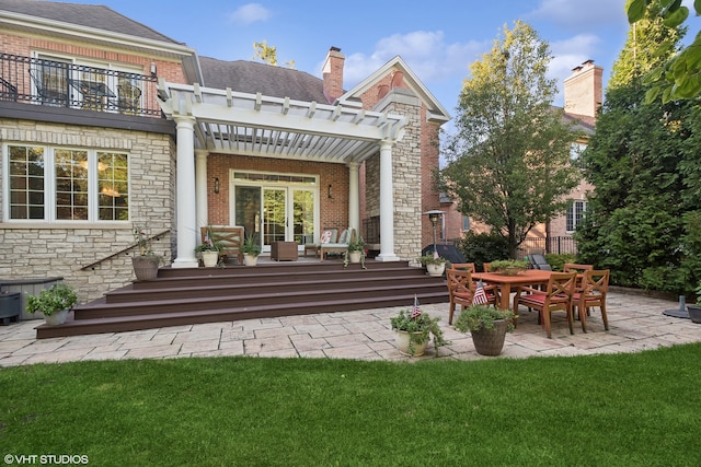 rear view of property with a pergola, a patio area, and a lawn