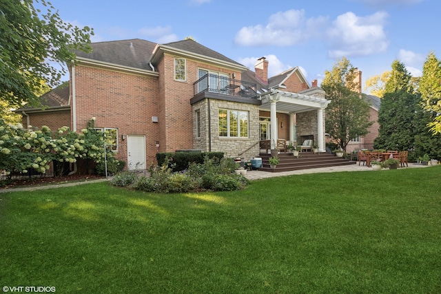 back of property featuring a patio, a balcony, a lawn, and a pergola